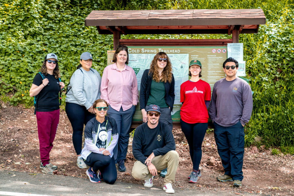 The TLi team (8 people) poses for a group photo at the Cold Spring Trailhead for a JAM Day in sunny Southern California.